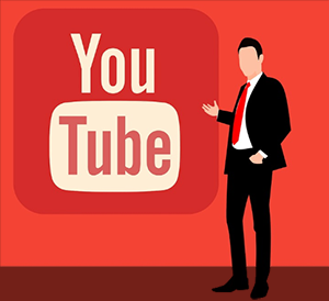 Man in suit pointing to YouTube icon on red background
