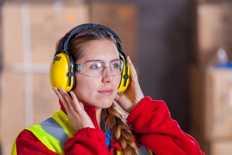 woman with safety glasses and hearing protection because facility needs ventilation system noise control