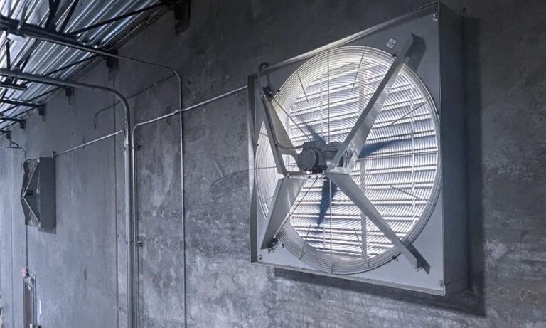 solar-powered fan installed on wall for industrial ventilation systems