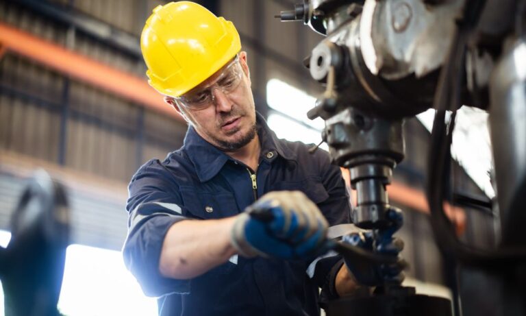 man working safely with machinery in building equipped with industrial ventilation systems